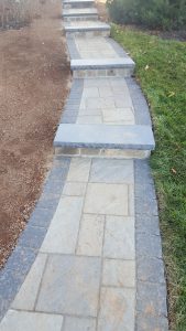 residential walkway made of stone pavers with gradual steps