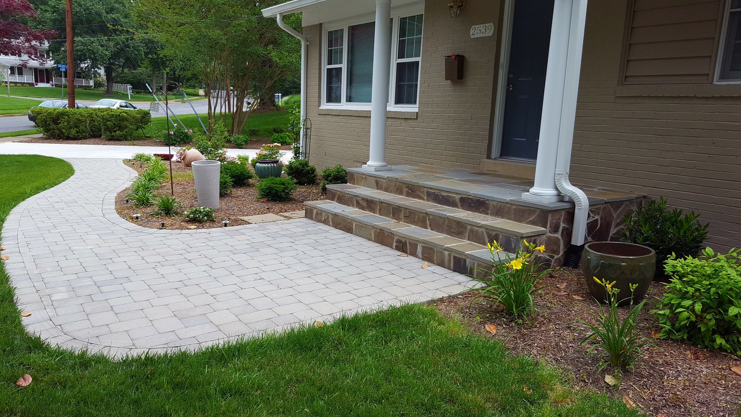 walkway with large stone landing and steps to front porch